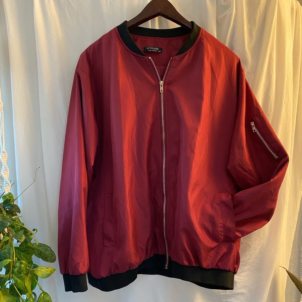 Burgundy zip up nylon jacket.